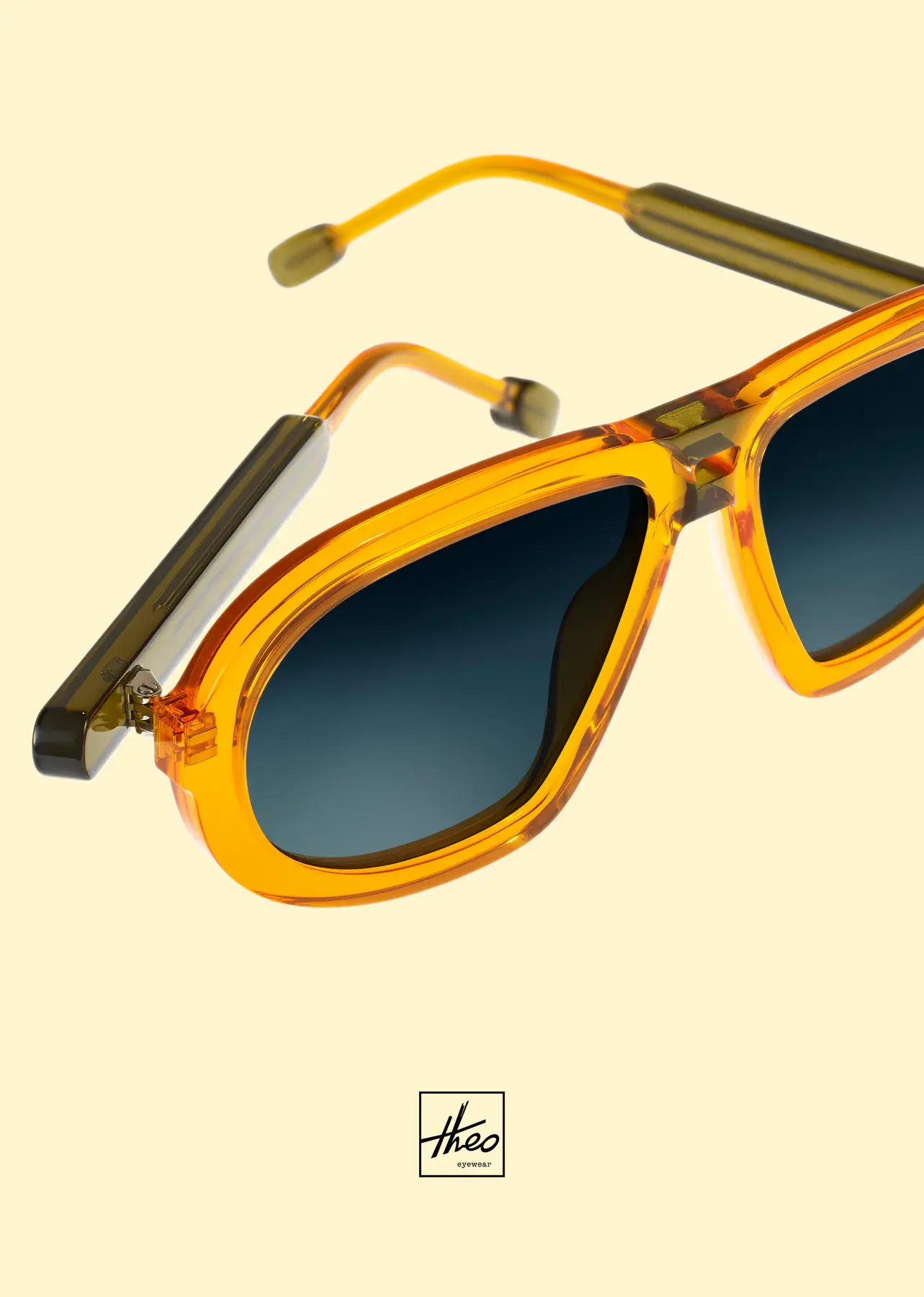 Amber and yellow theo sunglasses against a pale yellow background.