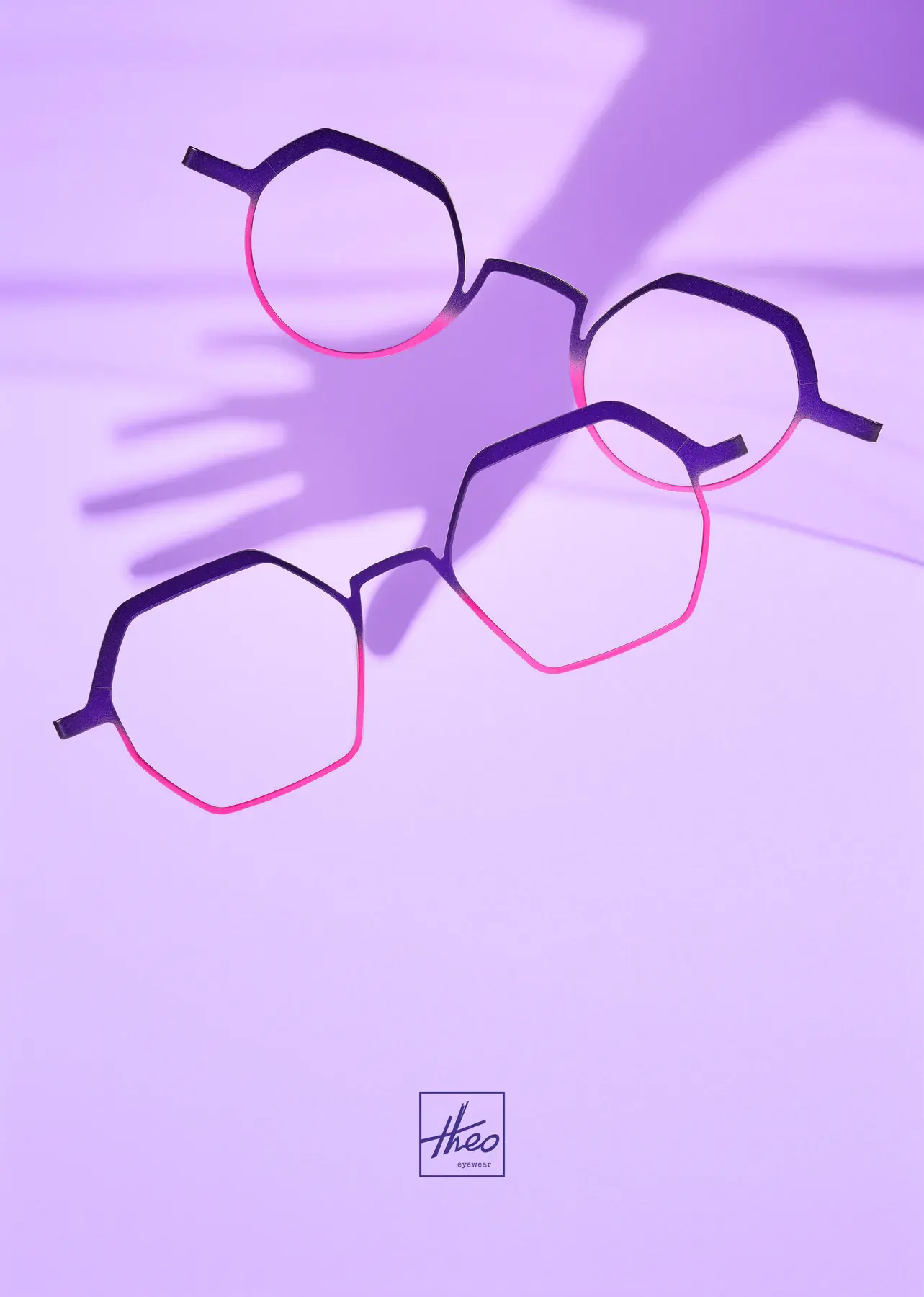 Violet and pink theo frames cast long shadows across a lilac background.